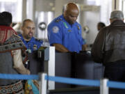FILE - In this Nov. 25, 2015 file photo, Transportation Security Administration agents check travelers identifications at a security check point area in Terminal 3 at O&#039;Hare International Airport in Chicago. Fliers who don&#039;t have the latest driver&#039;s licenses will have a two-year reprieve before their IDs are rejected at airport security checkpoints. Many travelers had been worried that the Transportation Security Administration would penalize them because of a federal law requiring the more-stringent IDs at the start of this year. (AP Photo/, File) (Nam Y.