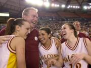 Prairie coach Al Aldridge congratulates Jessica Menkens, left, Ticey Westbrooks and Lauren Short, right, after Prairie beat Central Valley for the 4A State basketball championship at the Tacoma Dome.