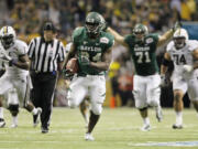 Baylor's Terrance Ganaway, center, rushes for a touchdown during the second half of the Alamo Bowl against Washington.