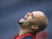 FILE - In this  Sept. 30, 2011 file photo, St. Louis Cardinals' Albert Pujols laughs during baseball practice, in Philadelphia. A person familiar with the negotiations says that three-time NL MVP Albert Pujols has agreed to a 10-year contract with the Los Angeles Angels. The person spoke on condition of anonymity Thursday, Dec. 8, 2011,  because the deal had not been announced.