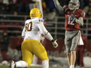 Washington State quarterback Connor Halliday (12) attempts a pass under pressure by Arizona State defensive tackle Will Sutton (90) during the first half Saturday.