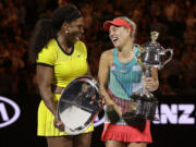 Angelique Kerber, right,  of Germany holds the trophy with runner-up Serena Williams of the United States after winning their women's singles final at the Australian Open tennis championships in Melbourne, Australia, Saturday, Jan. 30, 2016.