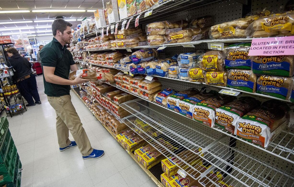 Bridgewater College junior communication major Jonah Barnhart, of Culpepper, Va., a floor stocker at Bridgewater Foods, races against shoppers stocking up before this weekend&#039;s snow storm to keep the bread aisle as full as possible for customers on Wednesday in Bridgewater, Va. Heavy snowfall that&#039;s predicted to arrive by the weekend from Appalachia to Philadelphia and maybe farther north.