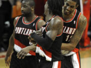 Portland Trail Blazers' LaMarcus Aldridge (12) celebrates with teammates Gerald Wallace, center, and Raymond Felton, left, as they go on to defeat the Washington Wizards 110-99 on Saturday.