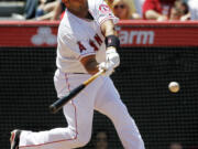 Los Angeles Angels' Albert Pujols hits a two-run home run against the Toronto Blue Jays during the fifth inning of a baseball game in Anaheim, Calif., Sunday, May 6, 2012. This was Pujols' first home run of the season.