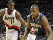 Portland Trail Blazers forward LaMarcus Aldridge, left, defends Charlotte Bobcats forward Boris Diaw during the first quarter of their NBA basketball game in Portland, Ore., Wednesday, Feb.