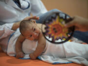 Three-month-old Daniel, who was born with microcephaly, undergoes physical therapy Thursday at the Altino Ventura Foundation in Recife, Brazil.