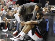 Portland Trail Blazers interim coach Kaleb Canales, left, talks with forward LaMarcus Aldridge as he waits to enter the game during the second half of their NBA basketball game against the Milwaukee Bucks in Portland, Ore., Tuesday, March 20, 2012.  Canales is filling in for ousted Blazers coach Nate McMillan.