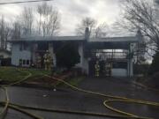 Firefighters respond to a house fire this morning on Northeast 83rd Street in Hazel Dell. The fire reportedly started in an attached garage but spread to the home.