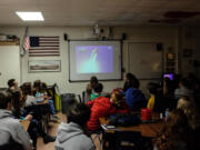 Eighth-grade students in Bangor Township, Mich., watch a video Thursday of the January 1986 Challenger space shuttle launch. The students were learning about teacher-astronaut Christa McAuliffe, whom their middle school is named after, on the space shuttle accident's 30th anniversary.