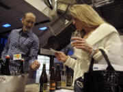 Craig Campbell, left, of Tieton Cider Works pours cider for a customer at the Taste Washington wine festival on March 31, 2012 in Seattle, Wash. Campbell is among a growing number of cider producers nationally, and in Washington state, several attend the annual wine event to allow people to sample their ciders.