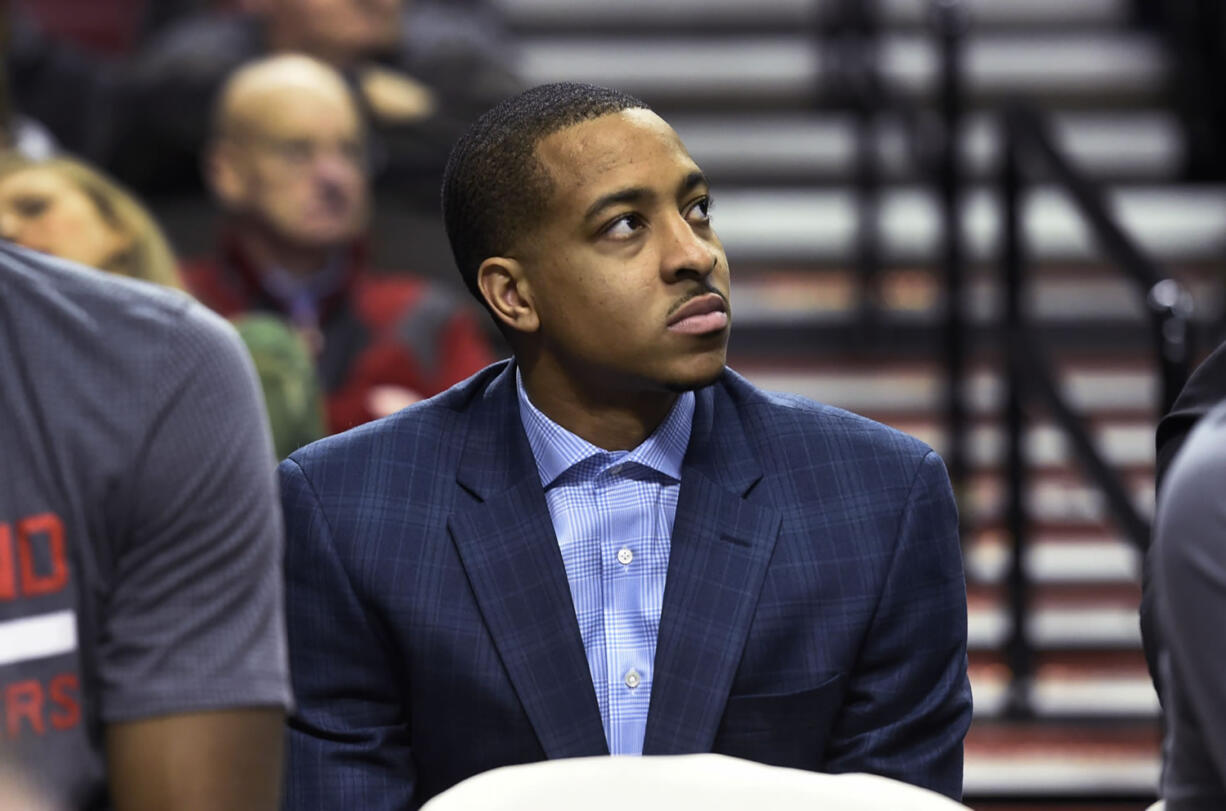 Portland Trail Blazers guard C.J. McCollum sits on the bench during the second half of an NBA basketball game against the Los Angeles Clippers in Portland, Ore., Wednesday, Jan. 6, 2016. McCollum was inadvertently left off the roster and did not play in the game. The Clippers won 109-98.