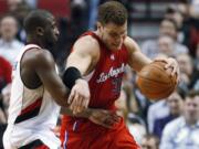 Los Angeles Clippers' Blake Griffin (32) drives past Portland Trail Blazers' Raymond Felton (5) in the second quarter of an NBA basketball game Thursday, Feb. 16, 2012, in Portland, Ore.