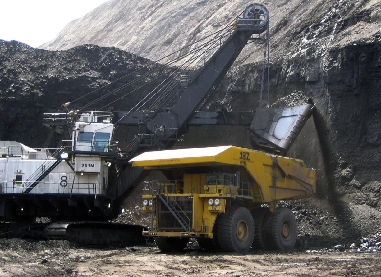 A shovel prepares to dump a load of coal into a 320-ton truck at the Black Thunder Mine in Wright, Wyo., in 2007.