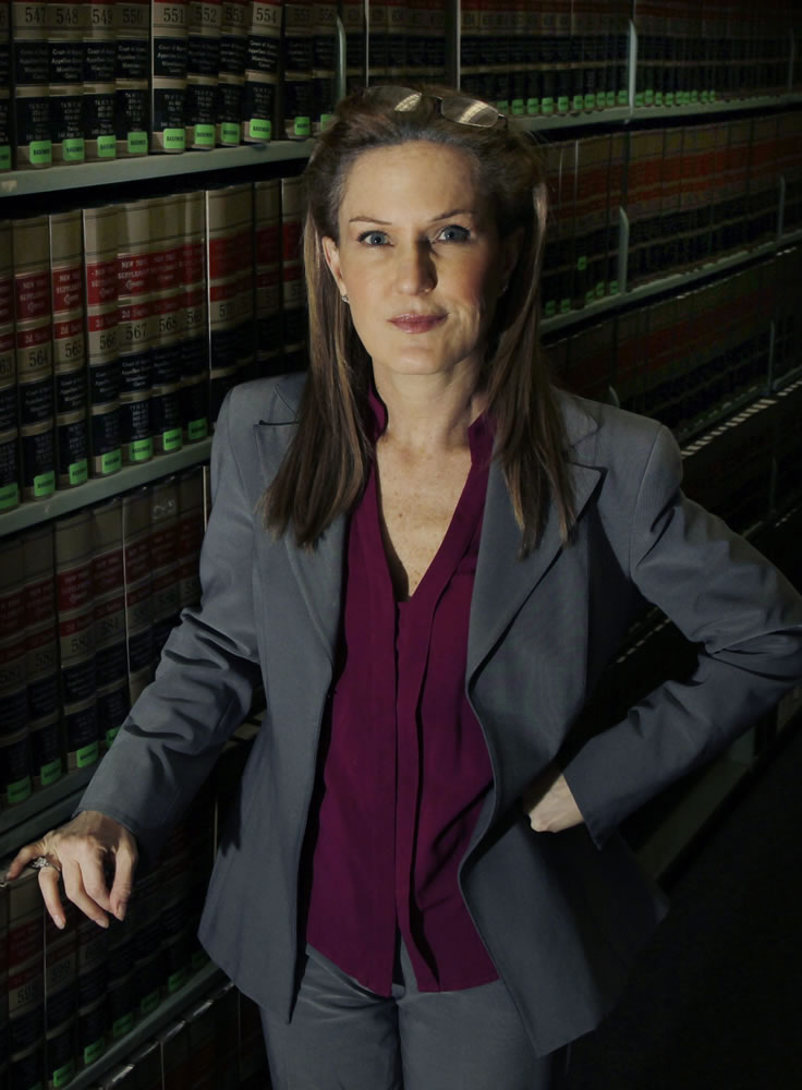 This Wednesday, March 14, 2012 photo shows attorney Wendy Murphy in the law library at the New England School of Law in Boston. Murphy, who has filed numerous Title IX complaints on behalf of victims, says colleges cave too easily in the face of threatened lawsuits from students accused of sexual violence. Most victims don't have the resources to pursue lawsuits, which is precisely why Title IX procedures on campus must work for them. That means putting a thumb on the scale in favor of victims - such as the &quot;preponderance of the evidence&quot; standard the Obama administration has said schools must use in adjudicating such cases.