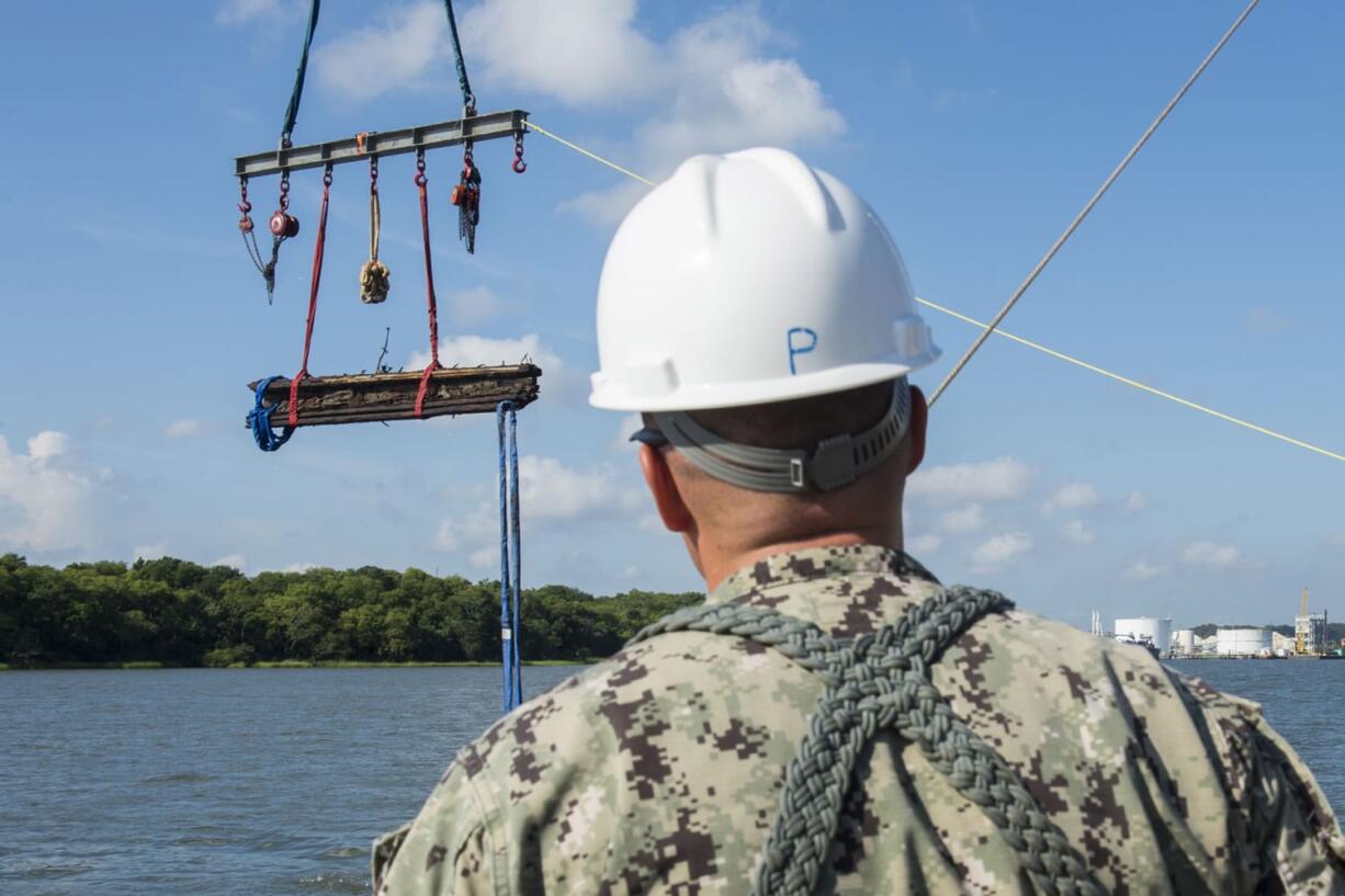 Chief Warrant Officer 3, Jason Potts, on scene commander for Task Element CSS Georgia, supervises as a piece of casemate, made of railroad ties and timber, which served as the outer layer of armor for CSS Georgia, is raised from the Savannah River in Savannah, Ga. After the government spent months recovering wreckage of the sunken gunship, roughly half of the nearly 30,000 artifacts discovered has been returned to the bottom of the Savannah River.