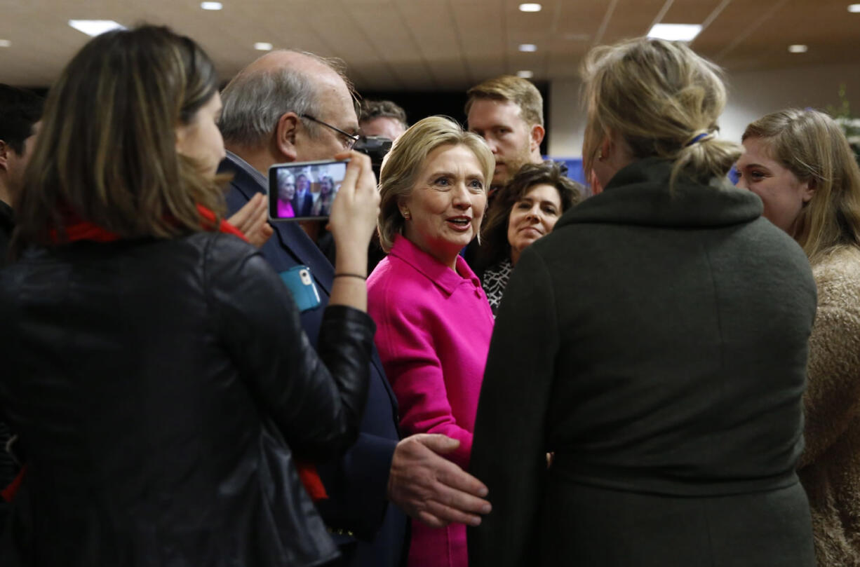 Democratic presidential candidate Hillary Clinton visits with attendees before speaking at the Scott County Democrats Red, White and Blue Banquet in Davenport, Iowa, Saturday, Jan. 23, 2016.