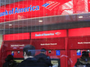 Bank of America customers use ATM machines Jan. 31 in New York.