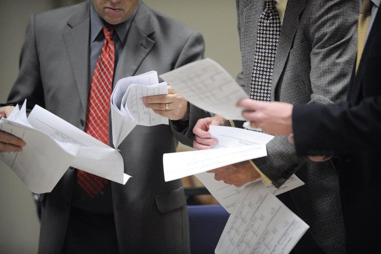 Clark County Commissioner Marc Boldt, left, and Jeff Hamm, executive director of C-Tran, look over election results at Gaiser Hall at Clark College Tuesday November 8, 2011 in Vancouver, Washington.