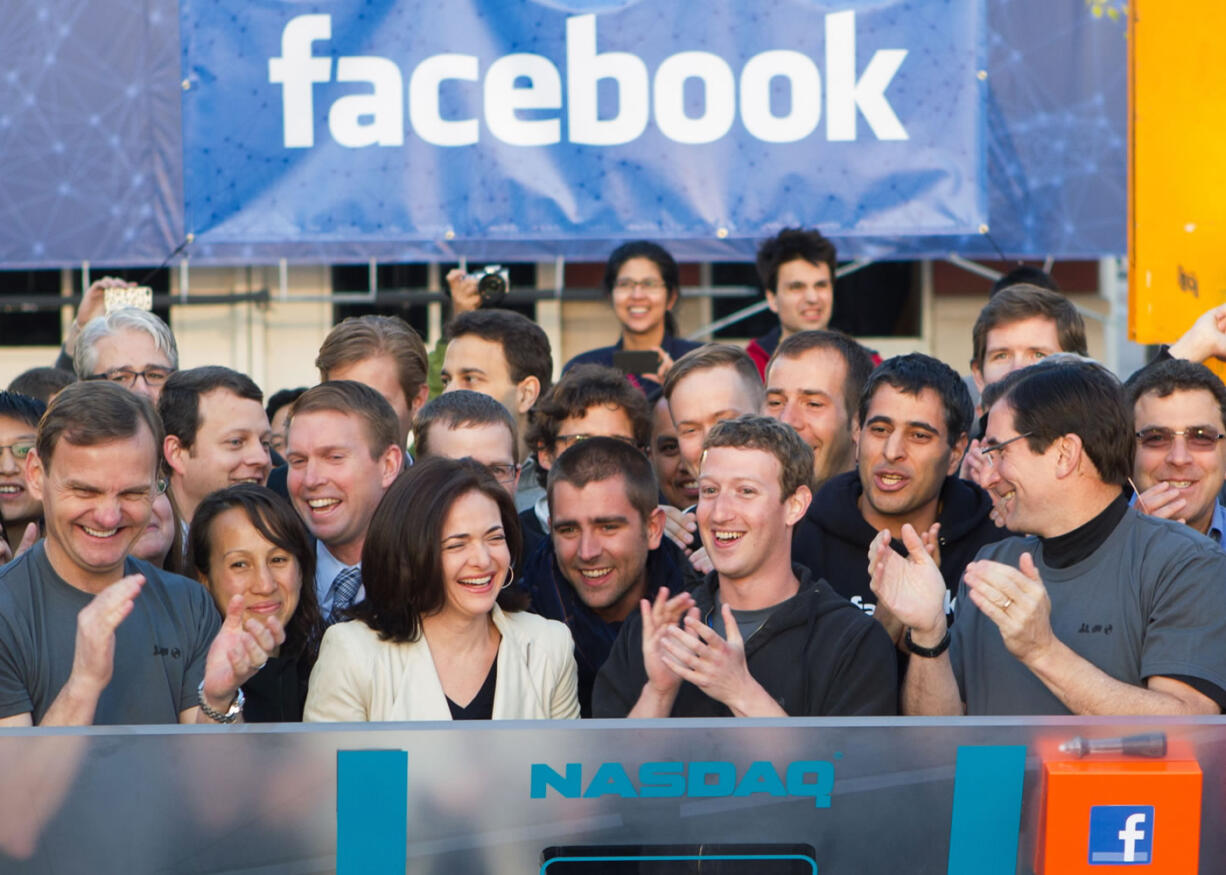 Facebook founder, Chairman and CEO Mark Zuckerberg, center, applauds at the opening bell of the Nasdaq stock market Friday from Facebook headquarters in Menlo Park, Calif., as the social networking giant launched its IPO.