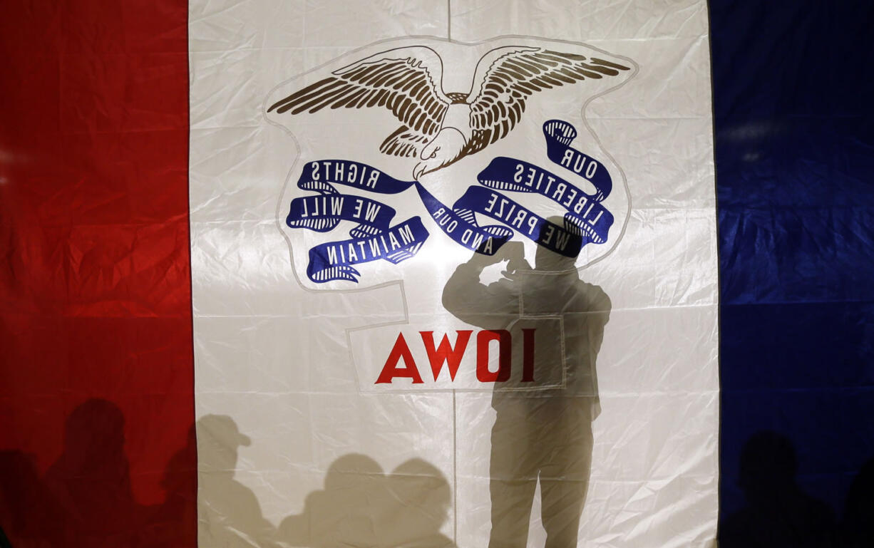 An audience member takes a photo as he waits for a speaker during a campaign rally Sunday at the University of Northern Iowa in Cedar Falls, Iowa.