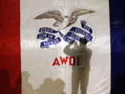 An audience member takes a photo as he waits for a speaker during a campaign rally Sunday at the University of Northern Iowa in Cedar Falls, Iowa.