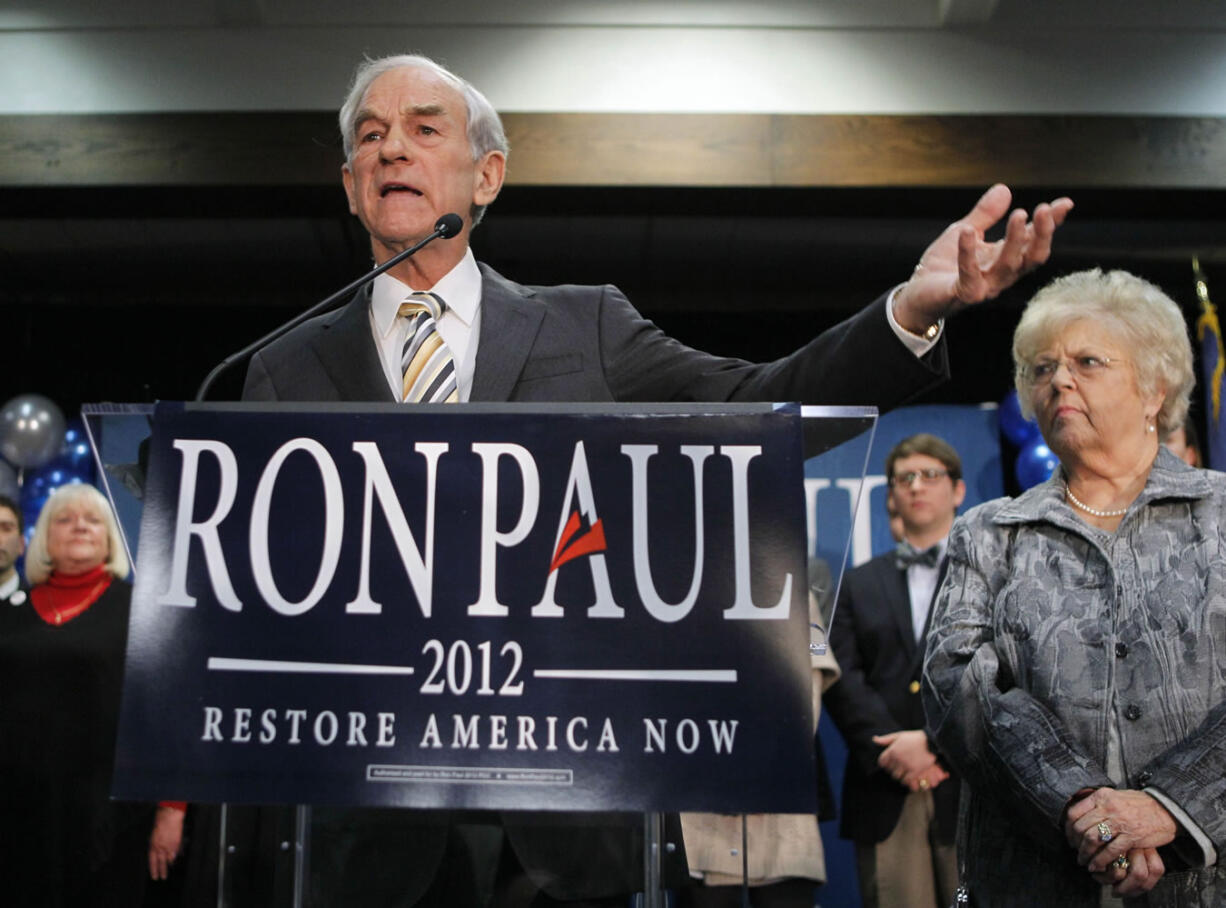 Republican presidential candidate Rep. Ron Paul, R-Texas, left, with his wife Carol Paul, speaks to supporters Saturday in Portland, Maine.