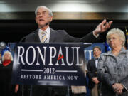 Republican presidential candidate Rep. Ron Paul, R-Texas, left, with his wife Carol Paul, speaks to supporters Saturday in Portland, Maine.