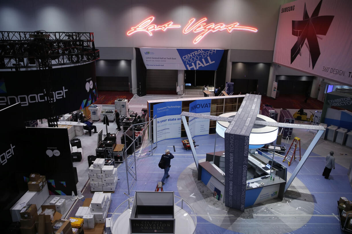 People work on booths in preparation for the International CES gadget show Sunday in Las Vegas. The show officially kicks off Wednesday.