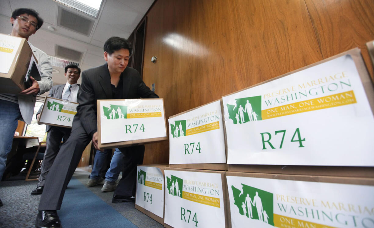 Supporters stack boxes of petitions for Referendum 74 along a wall in the Secretary of State's office to stop Washington's gay marriage law Wednesday in Olympia. The law was blocked from taking effect as opponents filed more than 200,000 signatures seeking a public vote on the issue in November. Preserve Marriage Washington submitted the signatures just a day before the state was to begin allowing same-sex marriages.