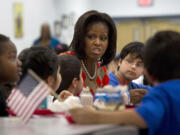 First lady Michelle Obama has lunch with school children at Parklawn elementary school in Alexandria, Va. A bipartisan Senate bill released Monday would revise healthier meal standards put into place over the last few years to give schools more flexibility in what they serve the nation&#039;s schoolchildren, easing requirements on whole grains and delaying an upcoming deadline to cut sodium levels on the lunch line.