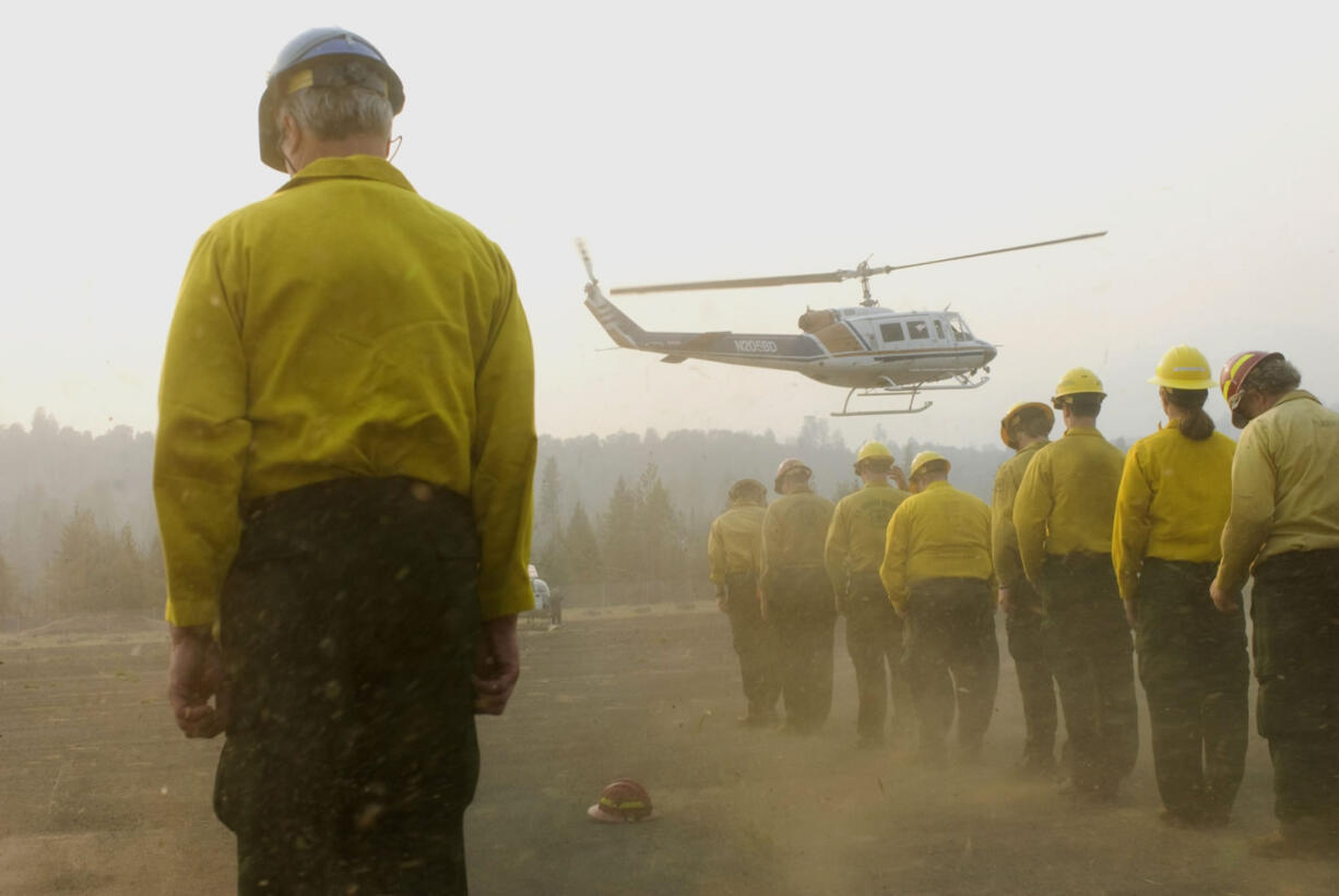 The remains of four firefighters are brought to the helibase in Weaverville, Calif., in 2008.