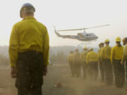 The remains of four firefighters are brought to the helibase in Weaverville, Calif., in 2008.