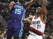 Charlotte Hornets forward Michael Kidd-Gilchrist (14) has his shot blocked by Portland Trail Blazers forward Noah Vonleh (21) during the first half of an NBA basketball game in Portland, Ore., Friday, Jan. 29, 2016.