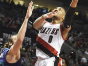 Portland&#039;s Damian Lillard (0) drives to the basket on Charlotte&#039;s Spencer Hawes during the second half of Friday&#039;s game. Lillard scored 22 points to go with five rebounds and six assists in the Blazers&#039; 109-91 win.