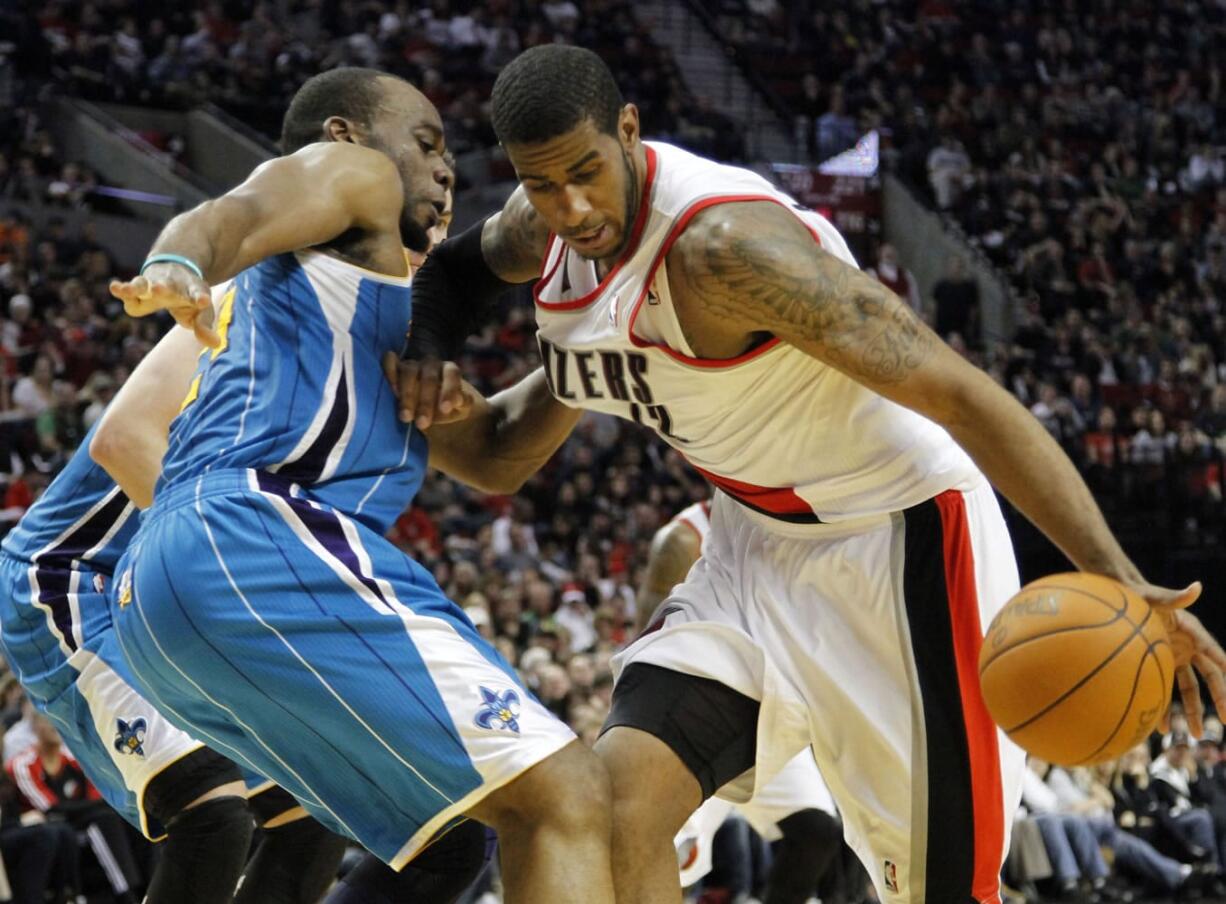 Portland Trail Blazers forward LaMarcus Aldridge, right, drives on New Orleans Hornets guard Carl Landry during the second half Thursday.