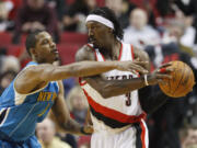 New Orleans Hornets' Trevor Ariza (1) defends against Portland Trail Blazers' Gerald Wallace (3) in the first quarter during an NBA basketball game Monday, March 5, 2012, in Portland, Ore.