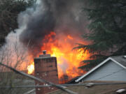 A fire rages at 3275 F Place in Washougal after shots were fired at firefighters on Dec.