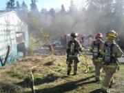 Firefighters with Clark County Fire &amp; Rescue and Clark County Fire District 6 on Monday morning doused a fire in an outbuilding near Ridgefield.