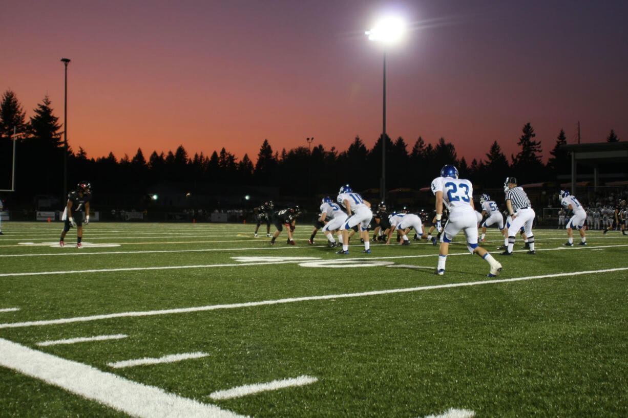 Jonathan Warner (1) and the Camas High School football players step up to the line of scrimmage against Mountain View Friday, at Doc Harris Stadium.