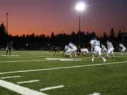 Jonathan Warner (1) and the Camas High School football players step up to the line of scrimmage against Mountain View Friday, at Doc Harris Stadium.