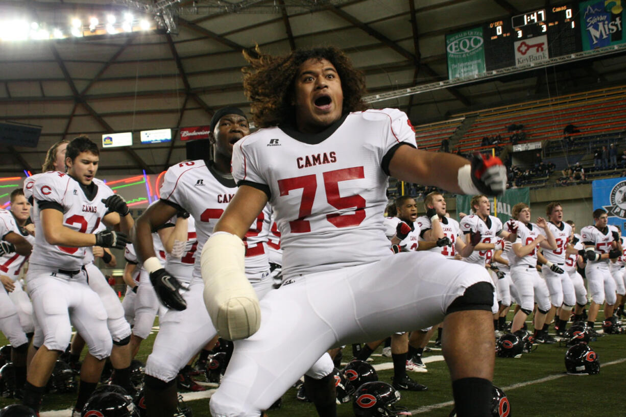 The Papermaker football players get the Camas crowd roaring with their tribal dance Friday, at the Tacoma Dome.