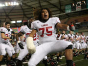 The Papermaker football players get the Camas crowd roaring with their tribal dance Friday, at the Tacoma Dome.