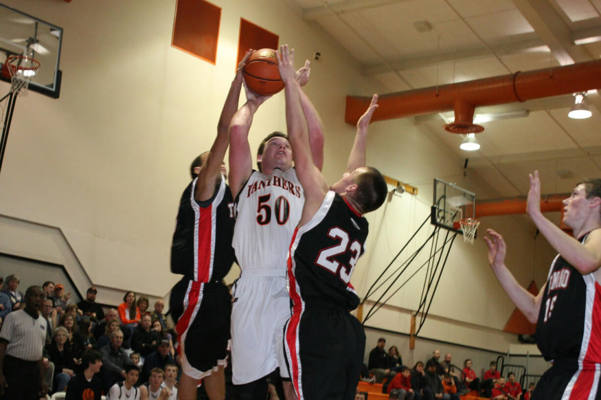 Two Tenino defenders are unable to stop Isaac Bischoff from making a basket Wednesday, at Washougal High School.