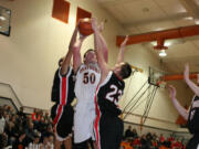 Two Tenino defenders are unable to stop Isaac Bischoff from making a basket Wednesday, at Washougal High School.