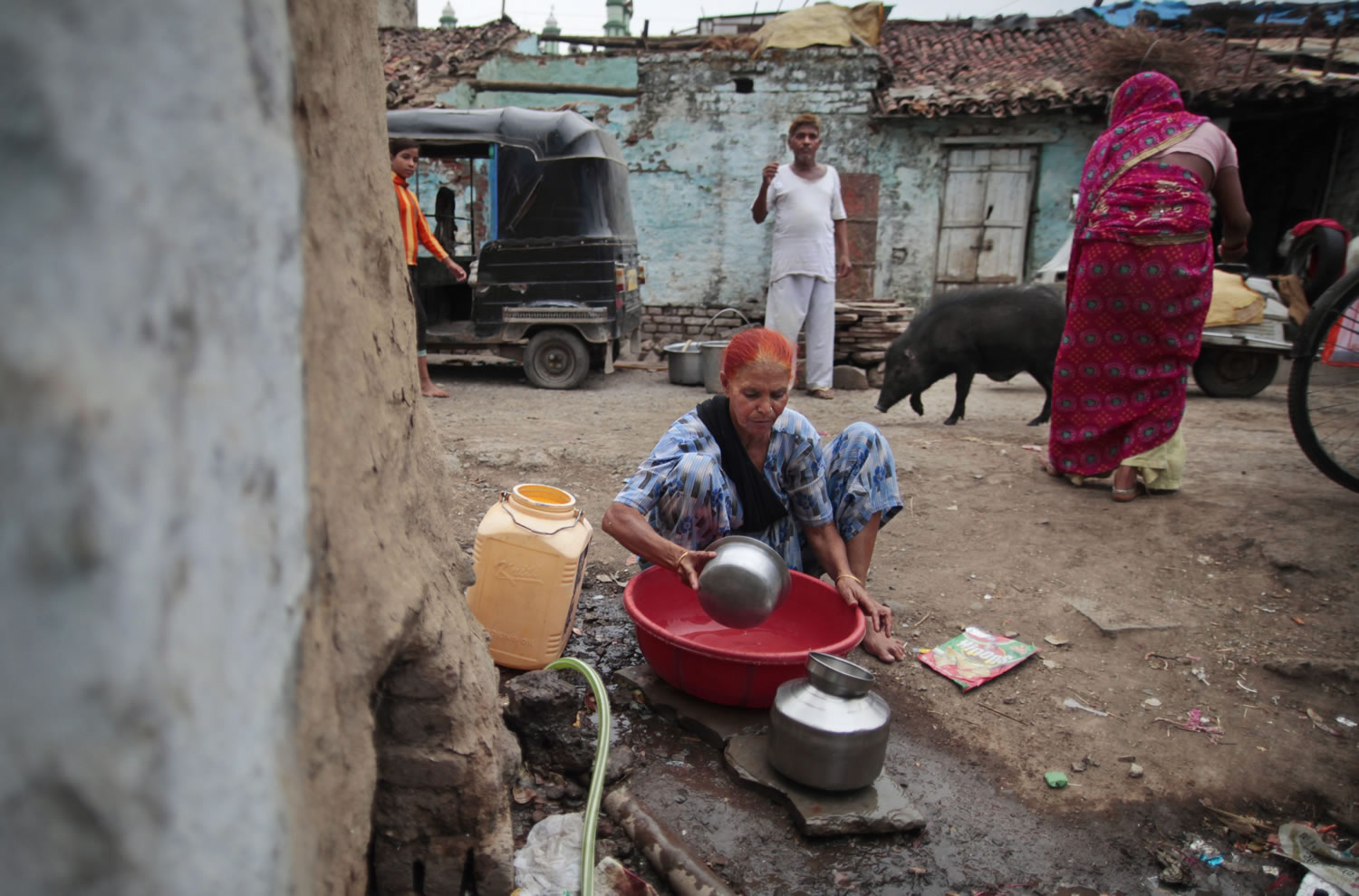 In this May 10, 2012 photo, Fatima Munshi collects water for domestic consumption from a community faucet outside her home in Khandwa, India. Living in Australia, Saroo Brierley, 30, was reunited with his biological mother, Munshi, in February 2012, 25 years after an ill-fated train ride left him an orphan on the streets of Calcutta.