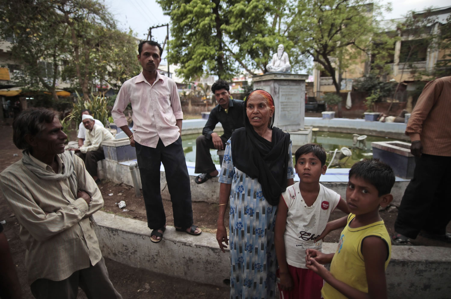 In this May 10, 2012 photo, Fatima Munshi, center, shows the fountain in Khandwa, India where her sons Saroo and Guddu played as she worked as a daily wage laborer about 25 years ago. Living in Australia, Saroo Brierley, 30, reunited with his biological mother, Munshi, in February 2012, 25 years after an ill-fated train ride left him an orphan on the streets of Calcutta.