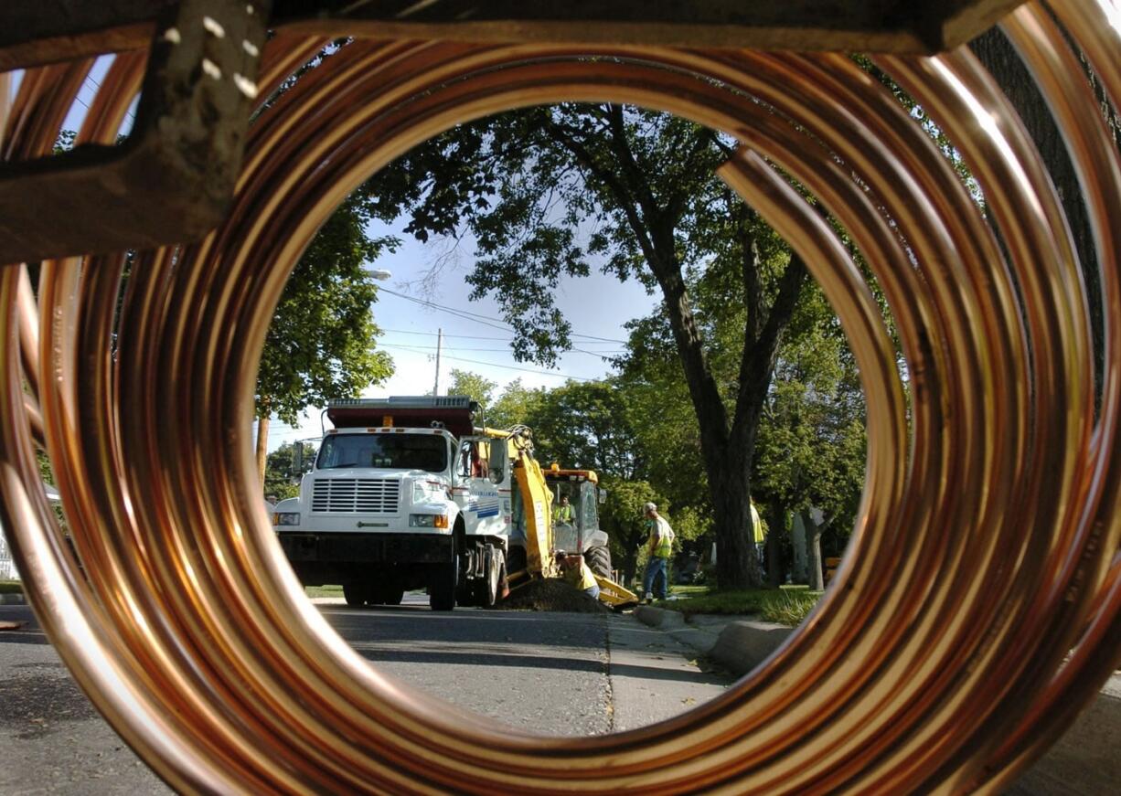 In this 2004 photo, city crews replace lead water pipes with copper piping in Lansing, Mich. Lansing has eliminated about 13,500 lead lines, similar to those buried beneath thousands of cities across the nation, and hopes to have all of them replaced within the next two years.