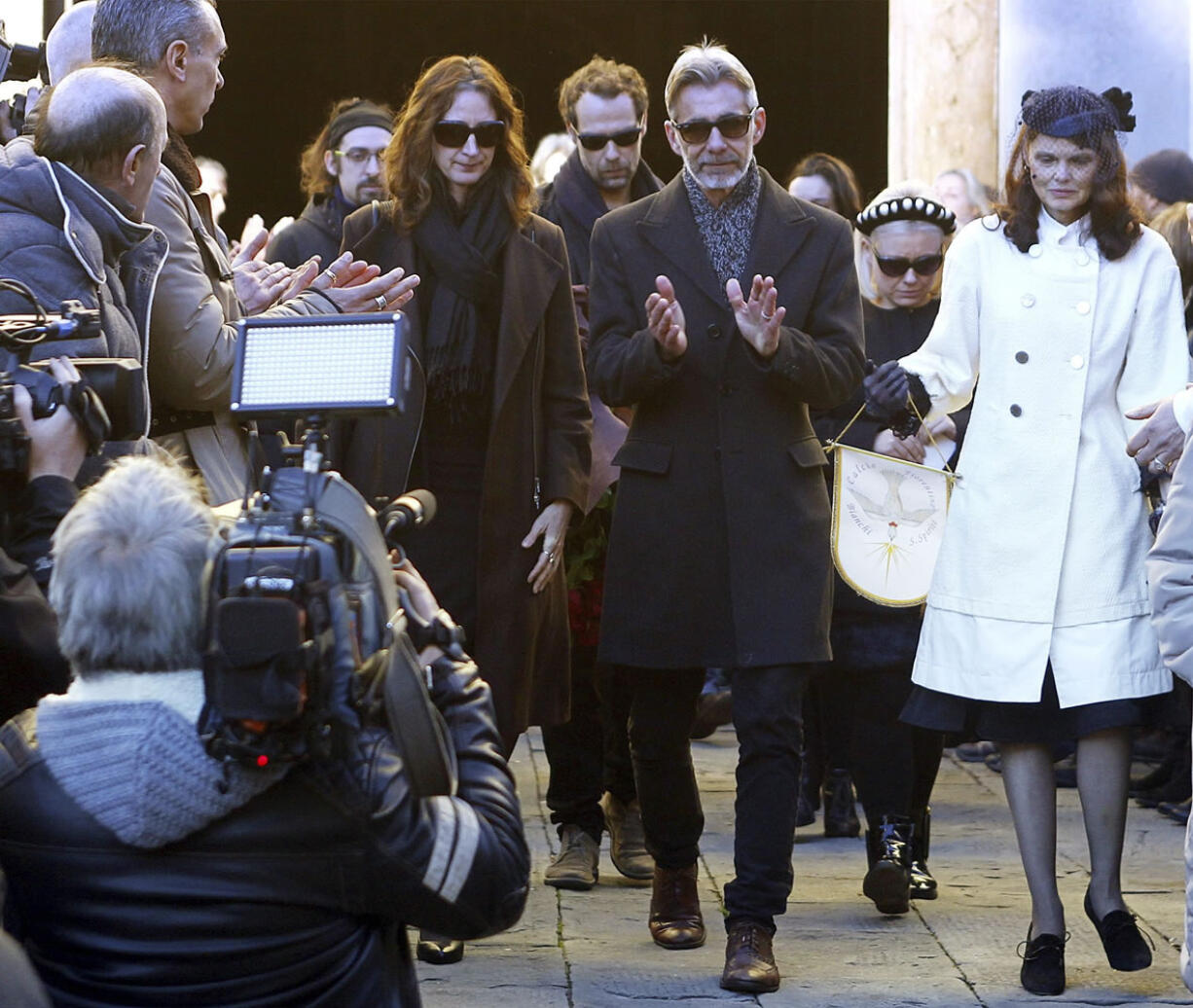 Walter and Paula Olsen, right, the parents of Ashley Olsen, 35, leave the church Friday after her funeral service at the Santo Spirito basilica in Florence, Italy. Prosecutors say she was killed by a Senegalese man, Cheik Tidiane Diaw, she met at a disco, after a night of cocaine-fueled sex followed by a fight. Behind Walter Olsen is Ashley&#039;s boyfriend, Federico Fiorentini.