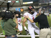 Camas head coach Jon Eagle embraces Jonathan Warner after he scores the first touchdown for th Papermakers at the Tacoma Dome.